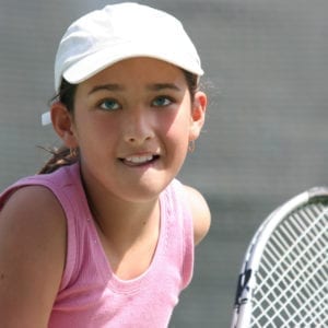 young girl playing tennis